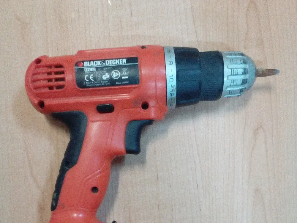 A cordless drill driver with its battery in the handle