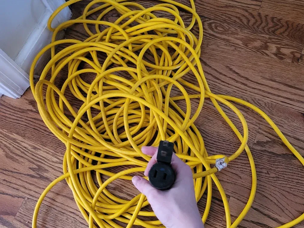 A coiled heavy-duty yellow extension cord