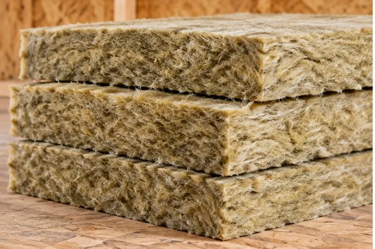 Close-up of stacked mineral wool slabs showing their dense fibrous edge
