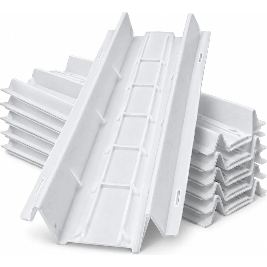 A stack of white plastic rafter vent baffles, ridged channels that keep a soffit vent clear under insulation